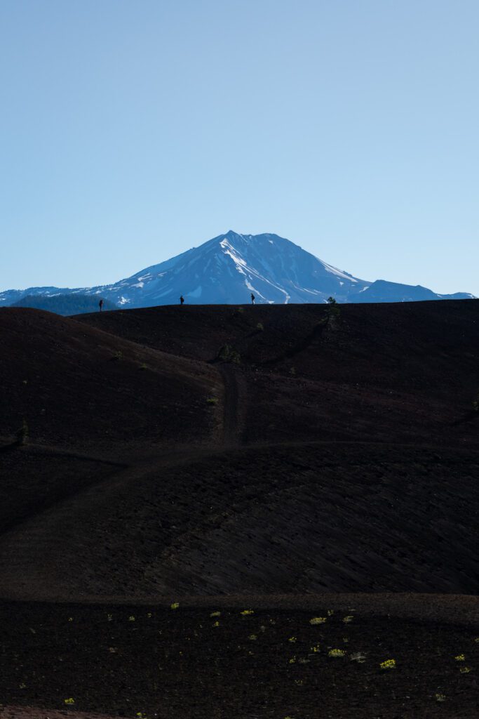 view of mount lassen as four people hike cinder cone